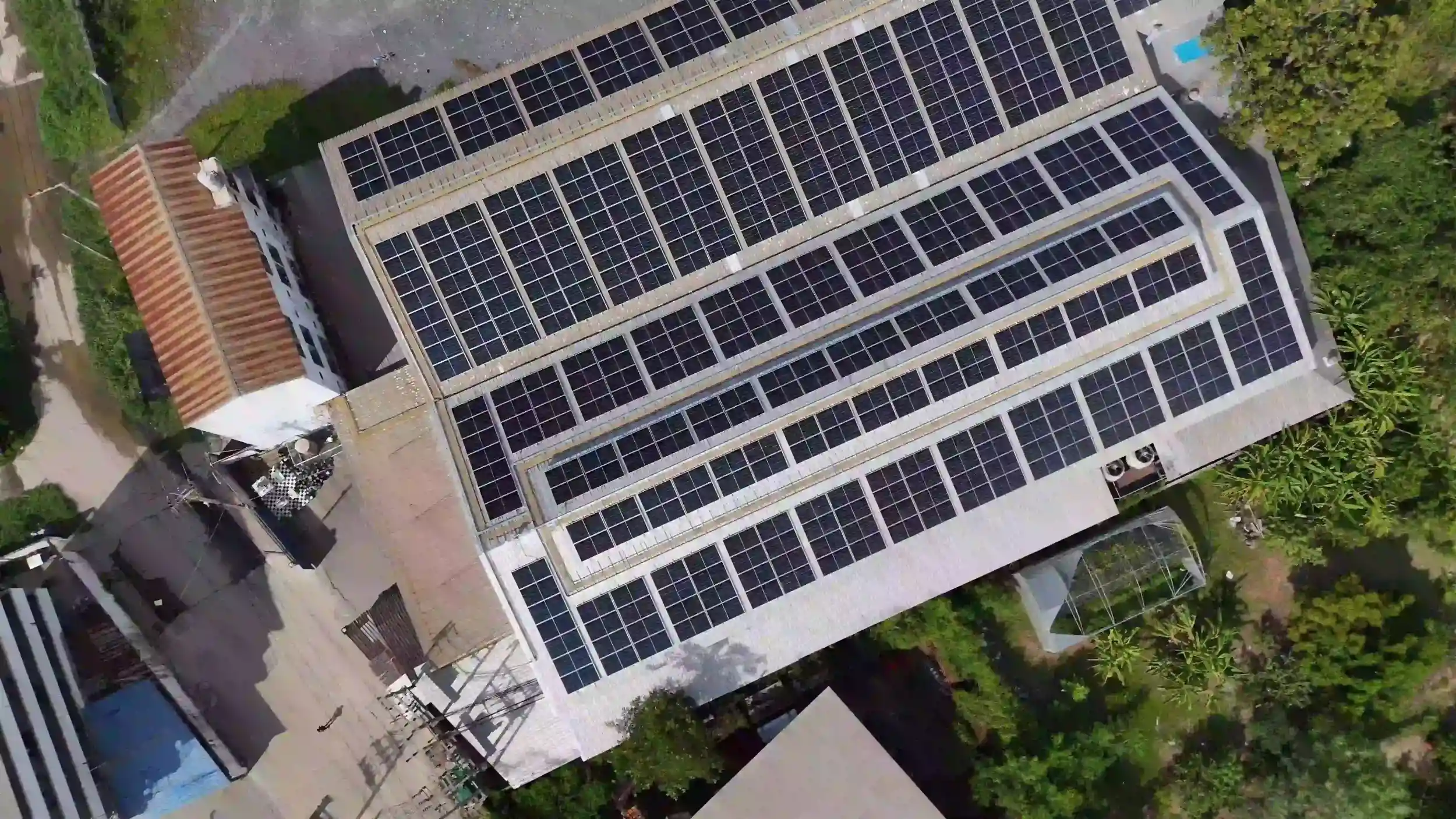 Aerial view of a large commercial rooftop solar system installed on a Rockhampton industrial building.