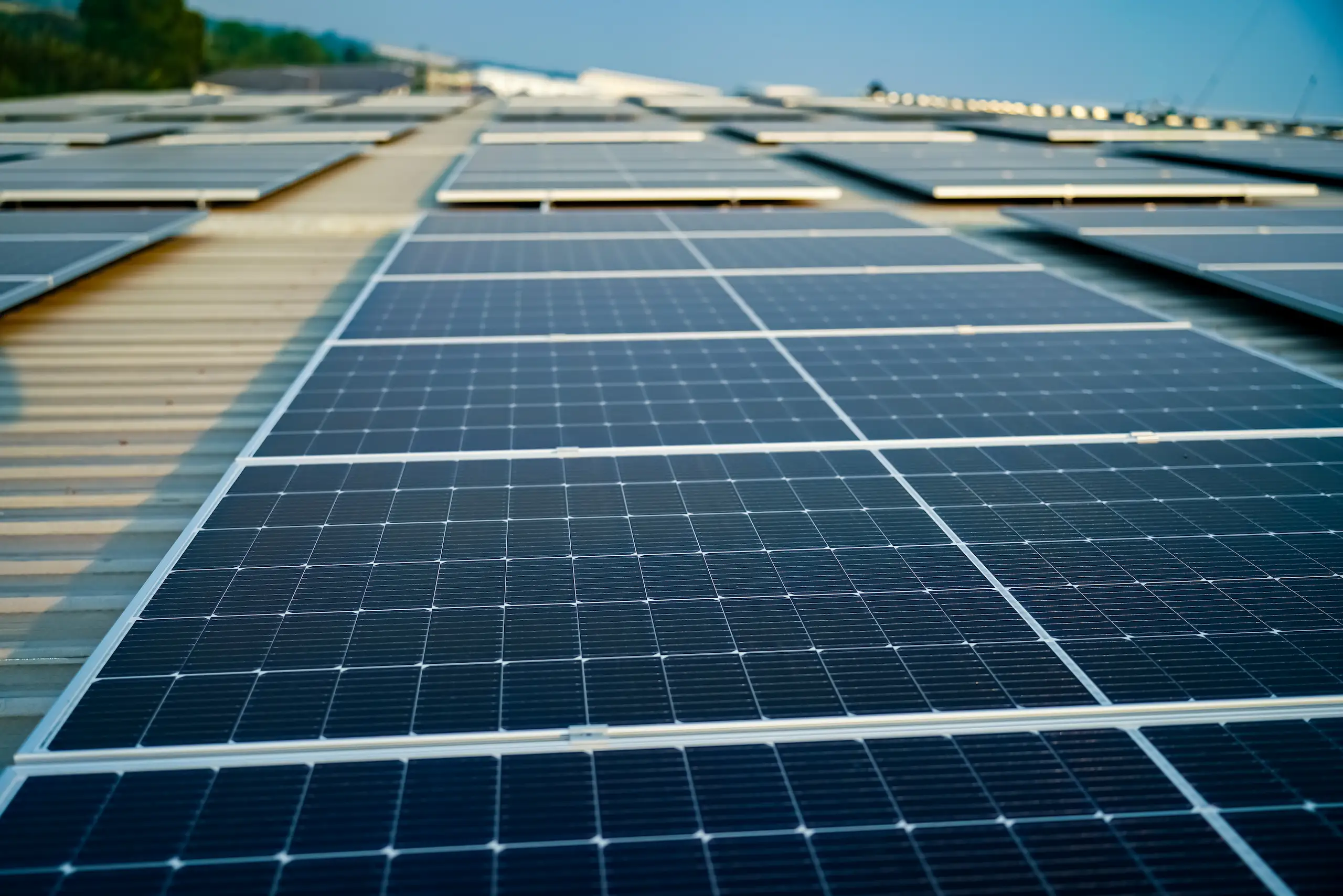 Close-up view of commercial-scale solar panels installed on a large Rockhampton rooftop.