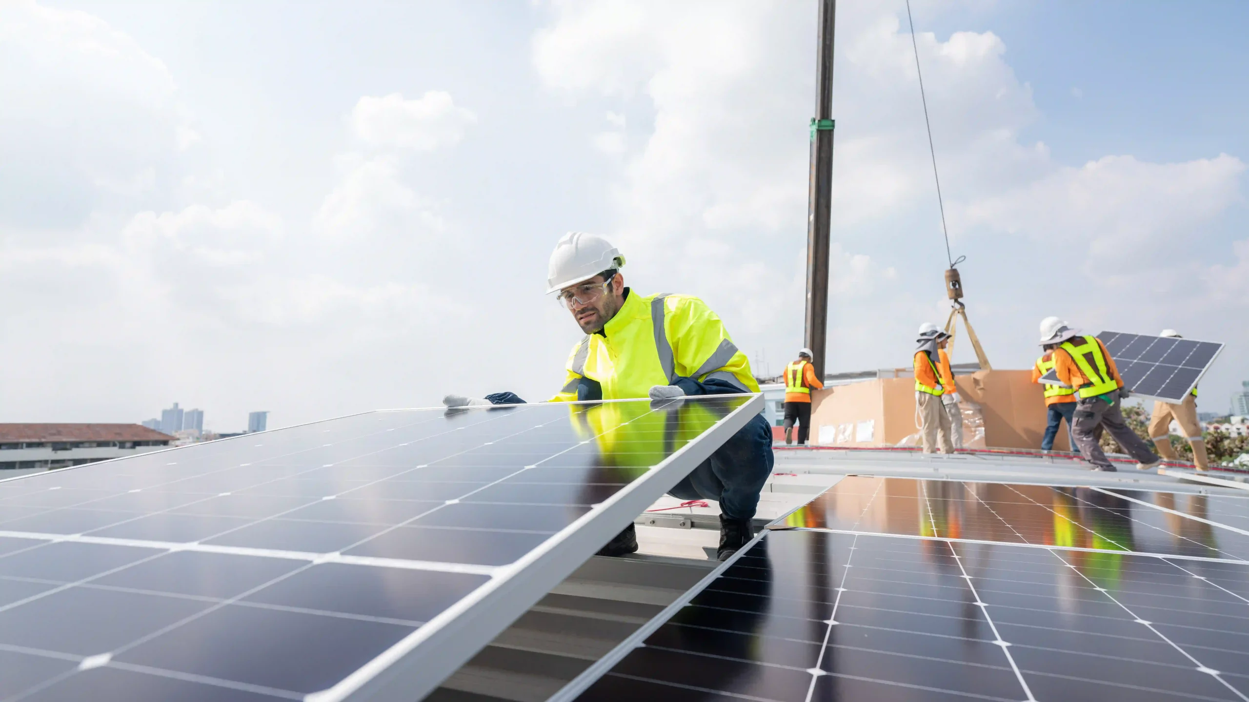 Technician installing solar panels on a rooftop in Rockhampton.