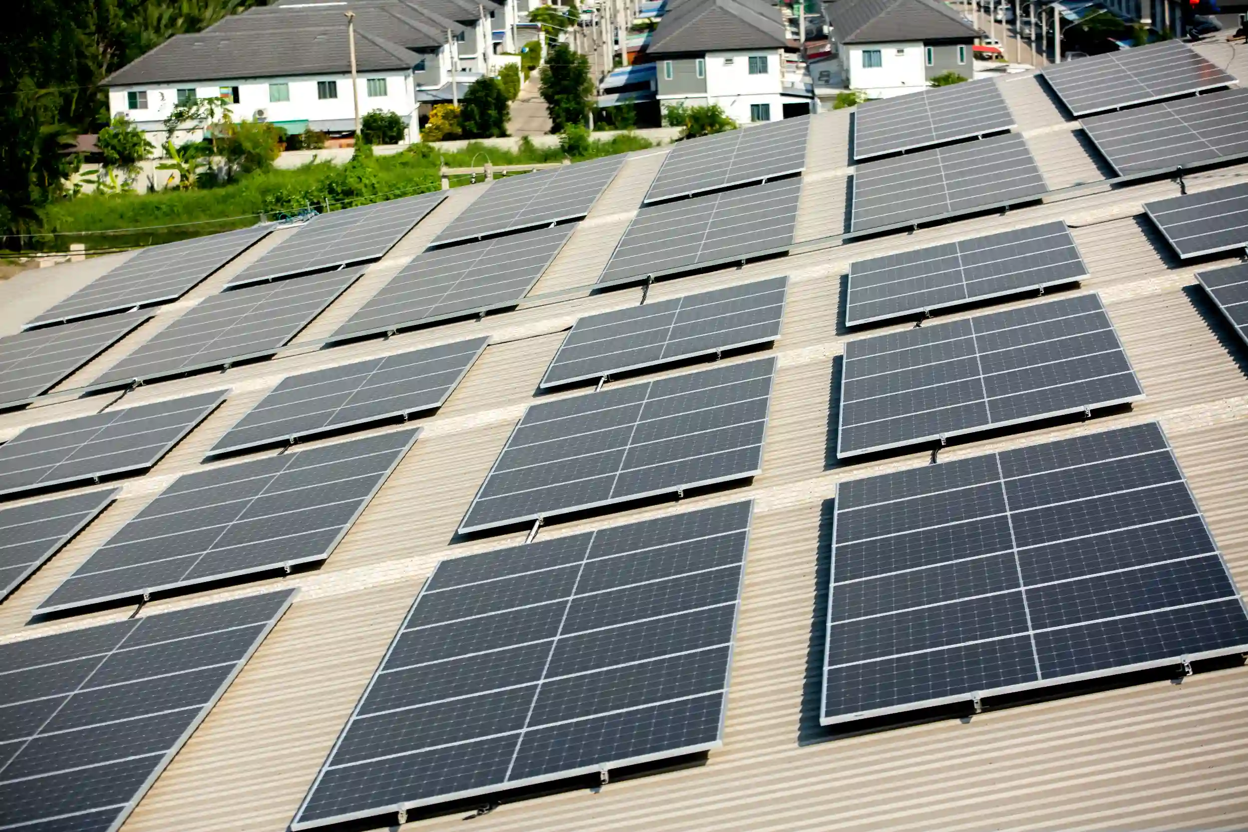 Wide rooftop solar panel system installed across a commercial building in Byfield, capturing maximum sunlight for high energy output.